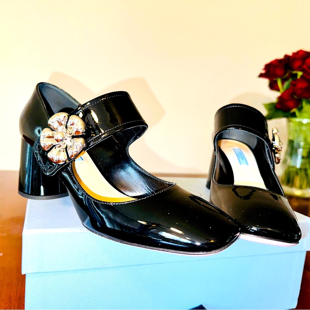 PRADA
Flower Embellished Patent Leather Mary Jane Pumps